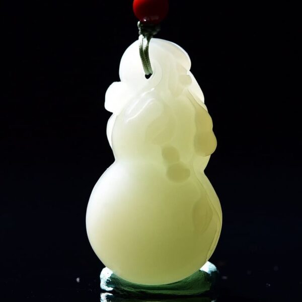 Close-up of warm, delicate texture and clever carving on Hetian Jade Fu Lu Shou Gourd pendant.