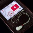 Certificate for the elegant Hetian Jade Fu Lu Shou Gourd pendant, highlighting its auspicious design and rich color.