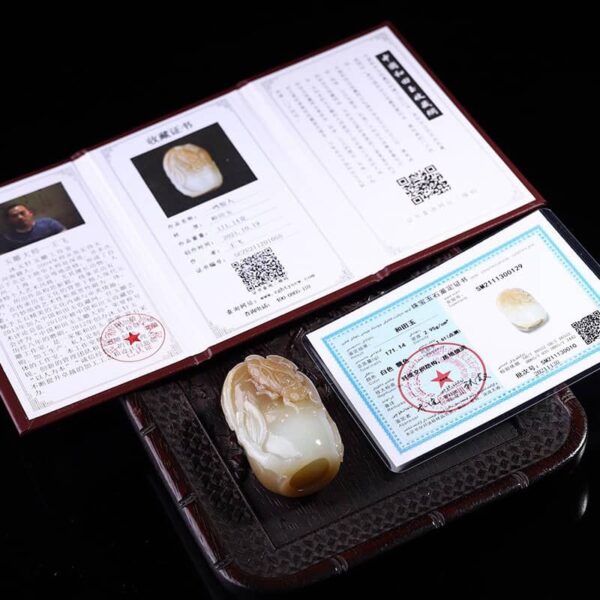 Natural Hetian Jade "Stunning Success" handpiece, showcasing unique design and smooth, comfortable feel for handling.