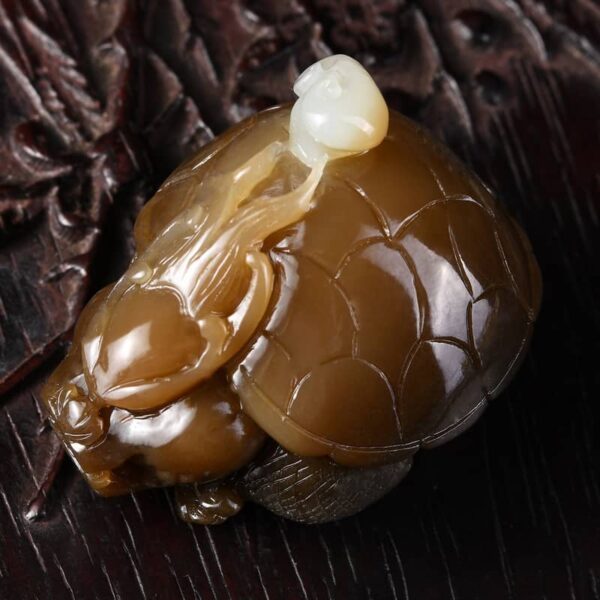 Close-up of exquisite Dragon Turtle carving on Hetian Jade handpiece, highlighting rich oily texture and vivid details.