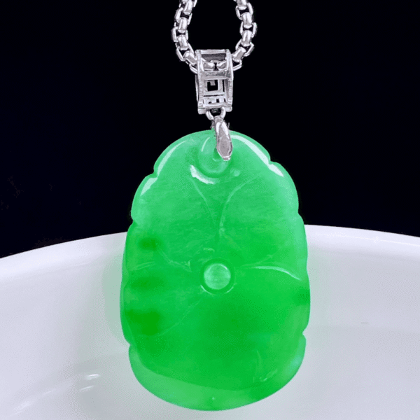 Close-up of exquisite 18K gold setting and rich vibrant green color on Lotus Leaf Jadeite Pendant.